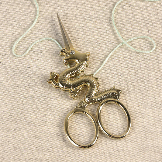 Borduurschaar in de vorm van een draak in een gouden kleur
