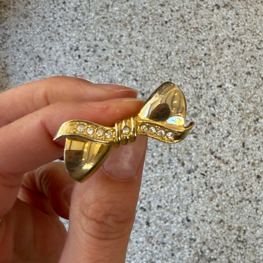Vintage broche strik met diamantjes