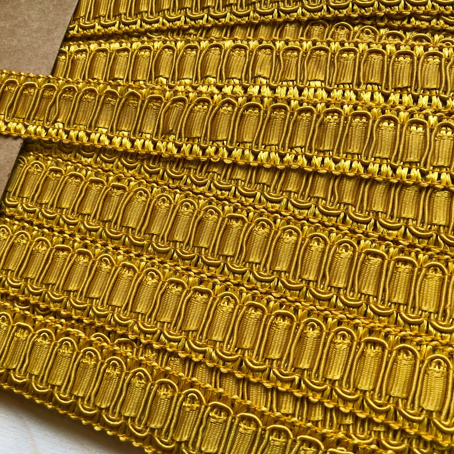 Dit prachtige sierband in een okergele kleur is perfect voor het afwerken voor mode of interieur projecten. 